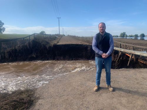 Picture of Hawkesbury City Mayor Patrick Conolly at a flooded Cornwallis Road