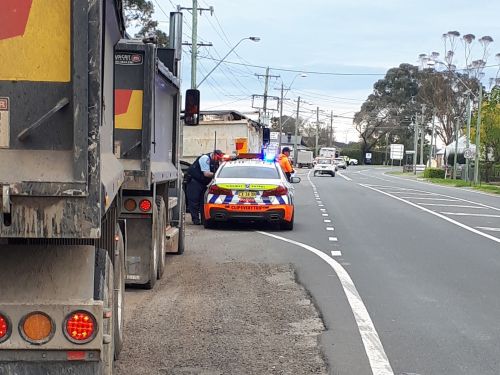 Image of police inspecting trucks