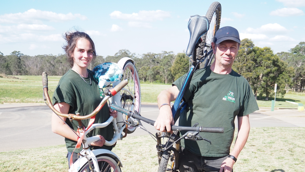 Revolve ReCYCLING staff holding bikes at the Hawkesbury Waste Management Facility