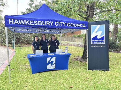 Picture of the customer service pop up tent and team