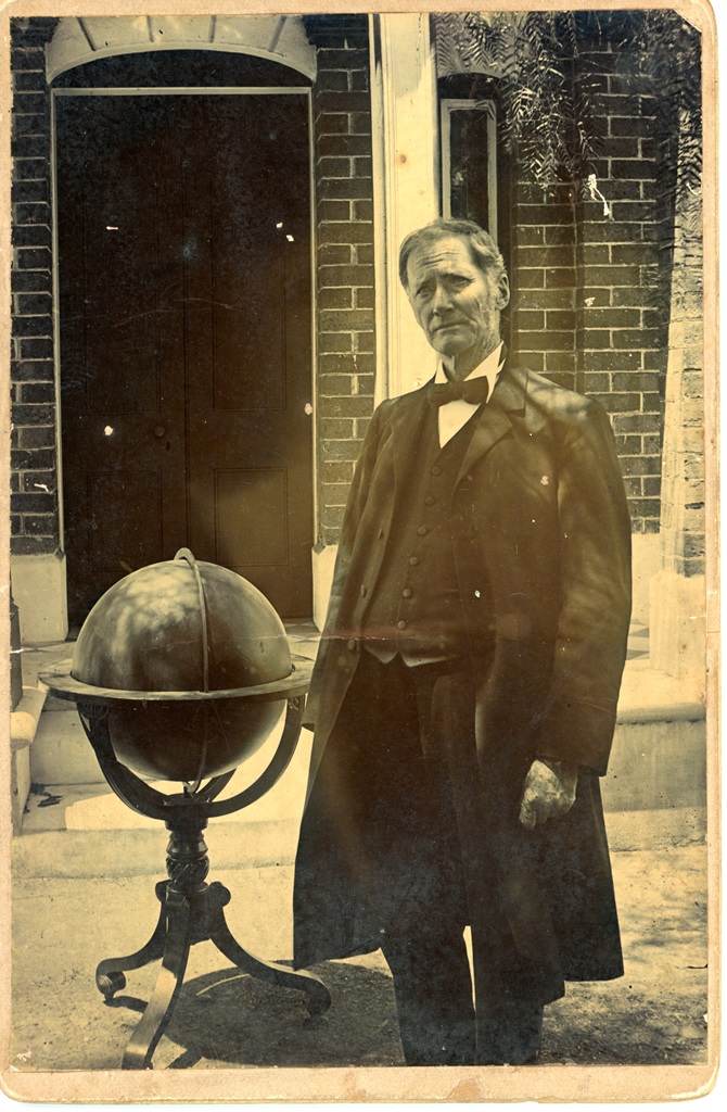 John Tebbutt in front of his observatory, posing with his celestial globe