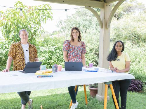 Picture of three women outside with their laptop computers.