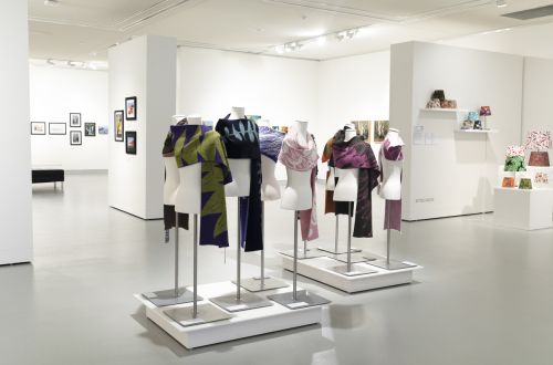 Picture of an exhibition at Hawkesbury Gallery, including brightly coloured clothing