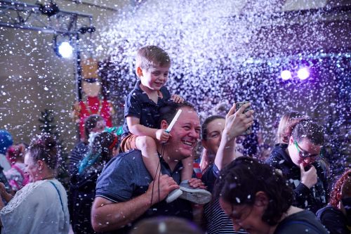 Father and child in a snow flurry at Light Up Windsor