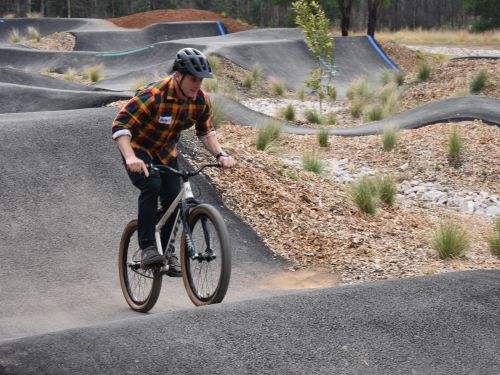A picture of a man riding on the pump track