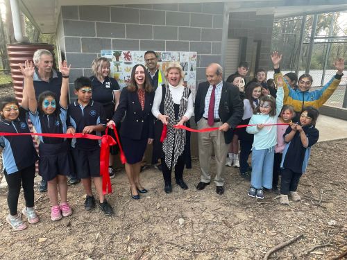 Hawkesbury City Councillor Amanda Kotlash (centre) cuts the ribbon with State Member for Hawkesbury Robyn Preston (left), Clr Eddie Dogramaci (right), with council staff and local residents. 