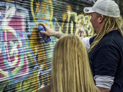 A picture of an aerosol artist teaching at the Street Speak workshop