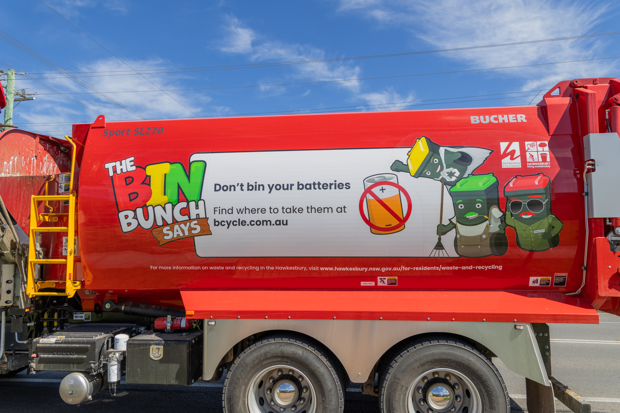 Garbage truck signage on not putting batteries in the bin