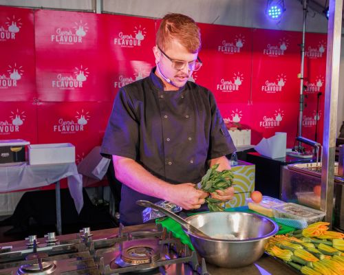 Image of a chef demonstrating cooking on stage