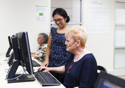 Staff with patron on computer