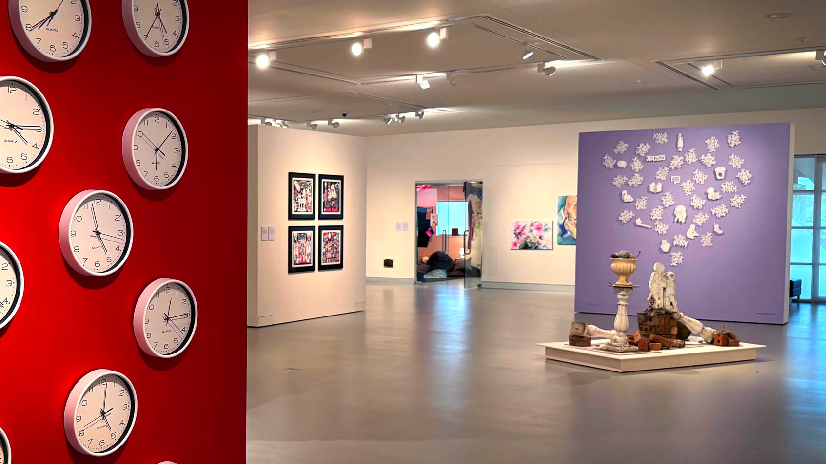 A gallery with artworks on the walls and an installation on the floor in the centre.